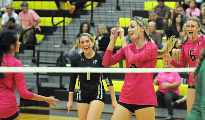 Bishop Moore players (from left) Sophia Iglesias, Lauren Vintilla, Jaide Wirth and Anika Groom celebrate one of Wirth's six kills against Lake Placid in Thursday's Region 2-4A quarterfinal match.